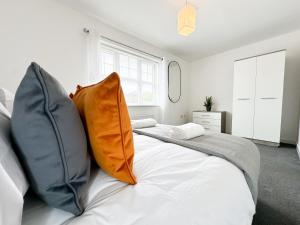 a white bed with two pillows on top of it at Aristotle House by Blue Skies Stays in Stockton-on-Tees
