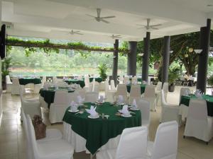 a banquet hall with white tables and white chairs at Sai Gon Phong Nha Hotel in Phong Nha +53 photos
