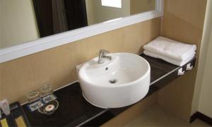 a bathroom with a white sink and a mirror at Sai Gon Phong Nha Hotel in Phong Nha