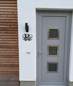 a white door with a sign on the side of a building at The Fehmarn Lodges - RELAX - in Fehmarn