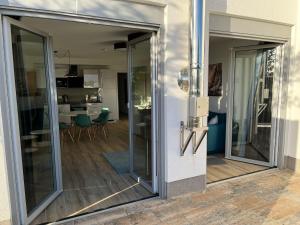a sliding glass door leading to a living room at The Fehmarn Lodges - OASIS - in Fehmarn