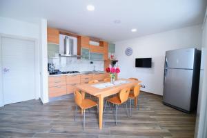 a kitchen with a table and chairs and a refrigerator at Pina's house in Pianillo