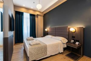 a hotel room with a large bed and a table at Hotel San Remo in Rome