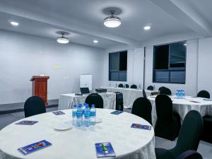 a conference room with tables and chairs and a podium at The New Njiro Legacy in Arusha