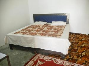 Ένα ή περισσότερα κρεβάτια σε δωμάτιο στο Rashi home stay
