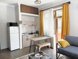 a kitchen and a living room with a table and a couch at Konukzade OldTown Apart in Antalya