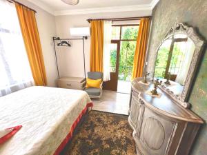 a bedroom with a bed and a mirror and a sink at Konukzade OldTown Apart in Antalya
