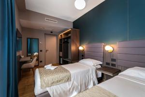 a hotel room with two beds and a bathroom at Hotel San Remo in Rome