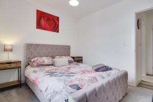 a bedroom with a large bed with a bed frame at Wimbourne Road Apartment 2 in Bournemouth