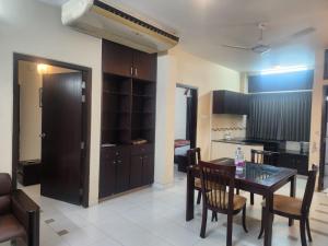 a kitchen and dining room with a table and chairs at Allegro Suites, Cox's Bazar in Cox's Bazar +13 photos