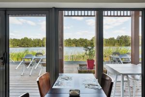 a dining room with a view of the water at All Suites La Teste – Bassin d’Arcachon in La Teste-de-Buch
