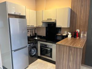 a kitchen with a refrigerator and a stove top oven at Studio cosy chic in Casablanca +5 photos