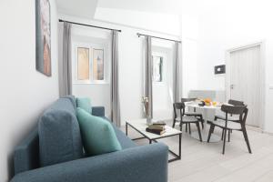 a living room with a blue couch and a table at Arieni Places in Corfu