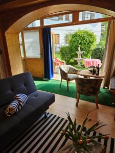 a living room with a couch and a table at Ferienwohnung Sonnenschein in Bayerisch Gmain +9 photos