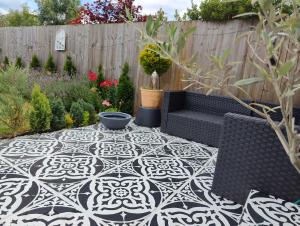 a patio with a black and white tiled floor at Modern large en suite loft room in Bromley, London in Bickley