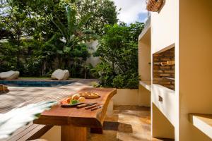 ジェリコアコアラにあるAldeia Jericoacoara - Suites Privativasのテーブルとフルーツの盛り合わせが備わる部屋
