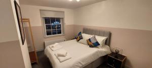a small bedroom with a bed with a window at 1 Bedroom Modern Living in The Old Bank House in Market Rasen in Market Rasen