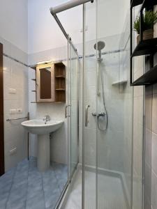 a bathroom with a glass shower and a sink at Casa Di Tino by GadraDoma in Assenza di Brenzone