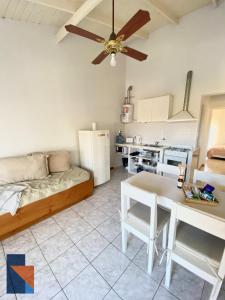 a kitchen with a couch and a table in a room at Ayacucho 59 in Venado Tuerto