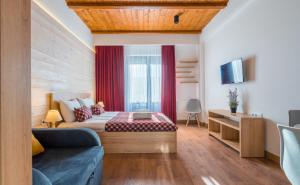 a hotel room with a bed and a couch at New Gudauri Ski4Life in Gudauri +22 photos
