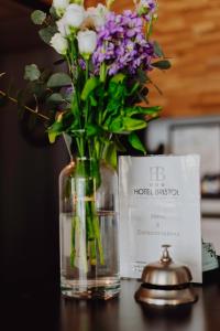 a vase filled with flowers sitting on a table at L'Hôtel Bristol in Caen
