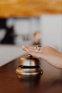 a woman with her hand on top of a bell at L'Hôtel Bristol in Caen