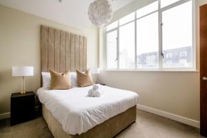 a bedroom with a large bed with a large window at Stunning Waterfront View Apartment by BOLD Apartments in Liverpool