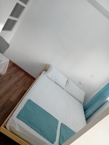 a bed in a room with a ceiling at Vokin Apartment in Gevgelija