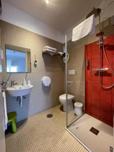 a bathroom with a shower and a toilet and a sink at 100 Contos in Porto