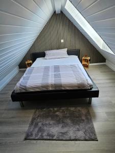 a bedroom with a large bed in a attic at FeWo Elke Lichtenau in Lichtenau