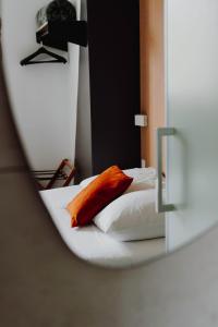 reflejo de una cama en un espejo en L'Hôtel Bristol en Caen