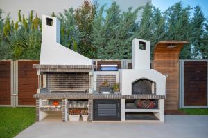 a play house with a brick fireplace at Villa MANDI & JANI in Laganas