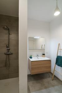 a bathroom with a sink and a shower at Nr 28 TravelHome in Heusden - Zolder