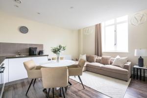 a living room with a table and a couch at Stunning Waterfront View Apartment by BOLD Apartments in Liverpool