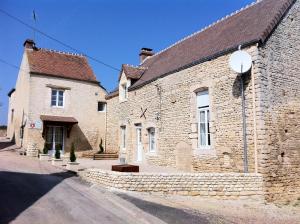 an old stone building with a street at Maison spacieuse avec piscine et vue sur jardin à Fourches in Fourches
