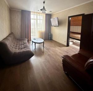 a living room with a couch and a table at Готель-ресторан Chalet in Bila Tserkva