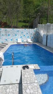 a person in a swimming pool with a water slide at Gabala 7 Villa in Vǝndam