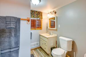 a bathroom with a toilet and a sink at Cottage with Deck and Bluff Lake Views Walk to Beach! in Lake
