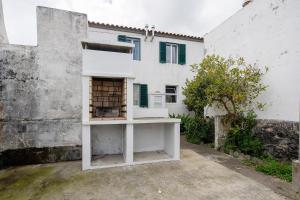 un edificio blanco con una jaula de pájaro delante de él en Casa Dona Isaura, en Ponta Delgada