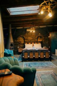 a bedroom with a bed and a stone wall at Areto Konak Otel in Dereköy