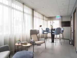 a waiting room with chairs and a table in a hospital at Hotel Lotus in Reykjavík