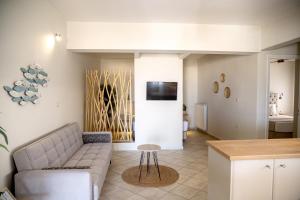 a living room with a couch and a table at Aegean Majesty in Azolimnos Syros