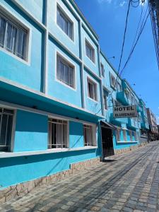 クリチバにあるHotel Blumenau Centroの通路脇の青白の建物