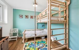 a room with two bunk beds and a swing at Lovely Home In Lembruch-dmmer See With Sauna in Lembruch