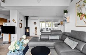 a living room with a couch and a table at Amazing Home In Grsten With House Sea View in Gråsten