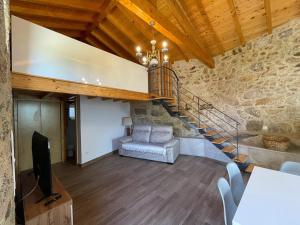 a living room with a staircase and a television at Casa da Maravilhas in Viana do Castelo