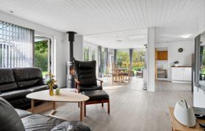 a living room with a couch and a table at 2 Bedroom Stunning Home In Vinderup in Vinderup