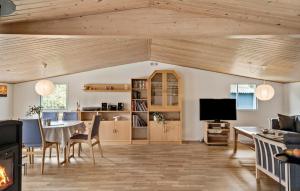 a living room with a table and a tv at Three-Bedroom Holiday Home In Gedser in Gedser