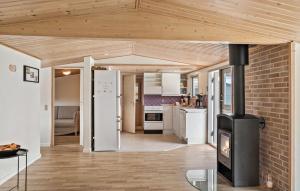 a kitchen with a brick wall and a stove at Three-Bedroom Holiday Home In Gedser in Gedser