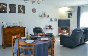 a living room with a table and chairs and a television at Gorgeous Home In Marcillac-La-Croisille in Marcillac-la-Croisille
